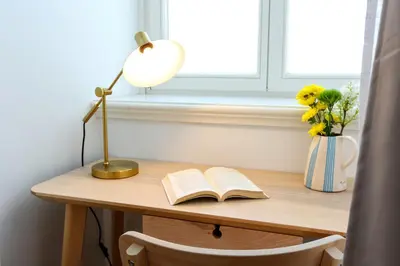 a desk with a lamp and an open book at Algarve Sweetness Apartment in Faro