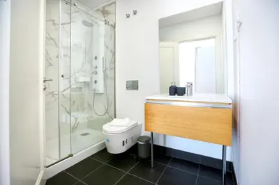 a bathroom with a shower and a toilet and a sink at Algarve Sweetness Apartment in Faro