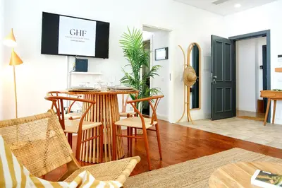 a living room with a table and chairs and a tv at Algarve Sweetness Apartment in Faro