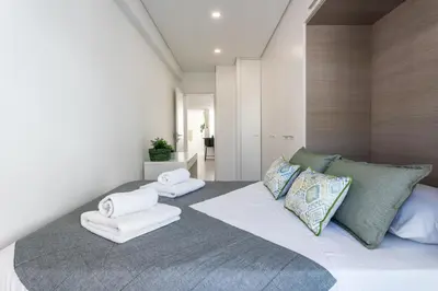 a bedroom with a large bed with towels on it at Privilege Deluxe Apartment Casa Mãe, Faro in Faro