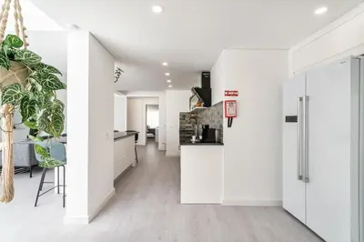 a kitchen with white walls and white floors at Privilege Deluxe Apartment Casa Mãe, Faro in Faro