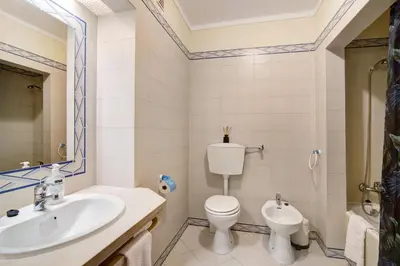 a bathroom with a toilet and a sink at Belavista House in Albufeira