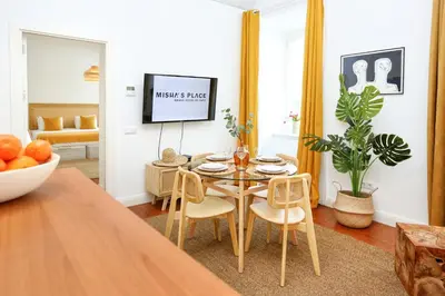 a dining room with a table and chairs at Beach Waves Apartment in Faro