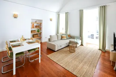 a living room with a couch and a table at Coast Guard Apartment in Faro