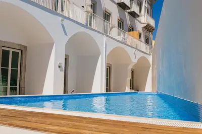 a swimming pool on the side of a building at Endless Summer Apartment in Faro