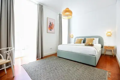a bedroom with a bed and a large window at Endless Summer Apartment in Faro