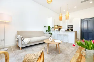 a living room with a couch and a table at Hot Breeze Apartment in Faro