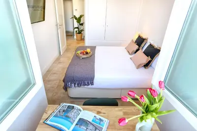 a living room with a couch and a table at Hot Breeze Apartment in Faro