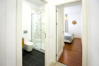 a bathroom with a shower and a toilet at Faro Away From Home Apartment in Faro