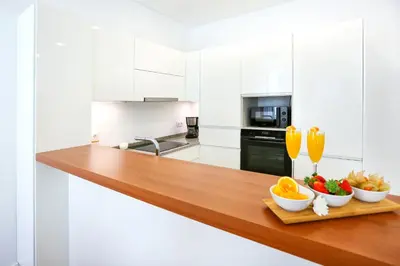 a kitchen with a wooden counter with fruit on it at Faro Away From Home Apartment in Faro