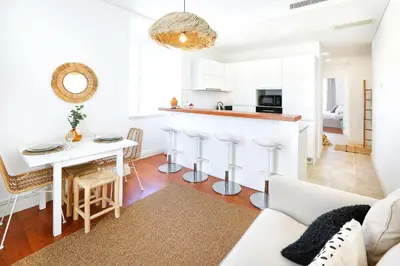 a living room with a kitchen and a dining room at Salty Spot Apartment in Faro