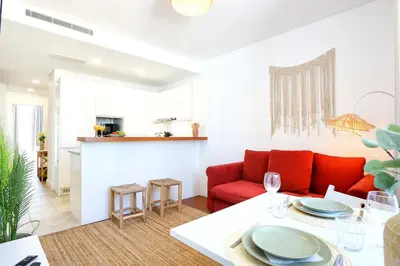 a living room with a red couch and a table at Xtraordinary Moments Apartment in Faro
