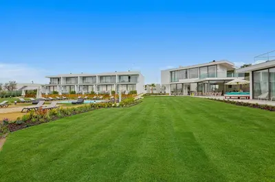 a large lawn in front of a large building at Balaia Senses in Albufeira