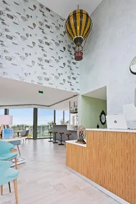 a lobby with a ceiling with fish painted on it at Balaia Senses in Albufeira
