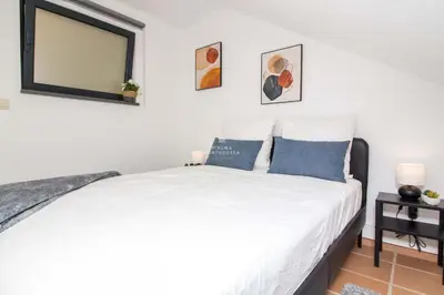 a bedroom with a bed with a mirror on the wall at Apartment Pine View- Falesia Beach By Dalma Portuguesa in Albufeira