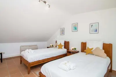 a bedroom with two beds with white sheets at Apartment Pine View- Falesia Beach By Dalma Portuguesa in Albufeira