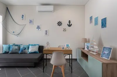 a room with a bed and a table and a desk at Lemon Hostel Faro in Faro