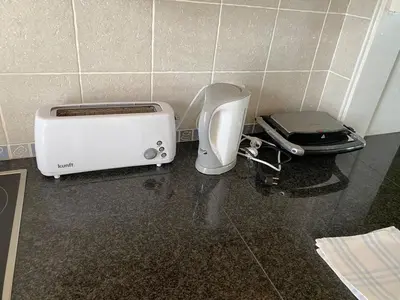 a toaster and a toaster sitting on a counter at The Albufeira Concierge - Moinho Sea Views & Pool in Albufeira