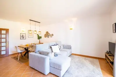a living room with a couch and a table at Villa Jasmin - Galé Bay in Albufeira