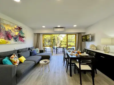 a living room with a couch and a table at Quarteira Stylish 1 by Homing in Quarteira