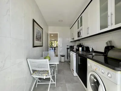 a kitchen with a sink and a dishwasher at Quarteira Stylish 1 by Homing in Quarteira