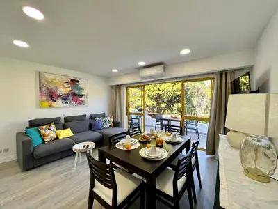 a living room with a table and a couch at Quarteira Stylish 1 by Homing in Quarteira