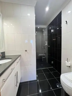 a bathroom with a shower and a toilet and a sink at Light House Luxury Villa in Albufeira