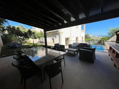 a patio with a table and chairs and a pool at Light House Luxury Villa in Albufeira