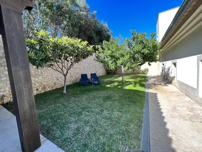 two blue chairs in a yard with trees at Light House Luxury Villa in Albufeira