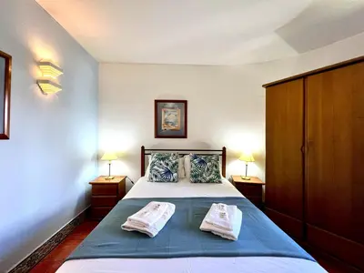 a bedroom with a bed with two pillows on it at Vilamoura Traditional Villa with Pool by Homing in Vilamoura