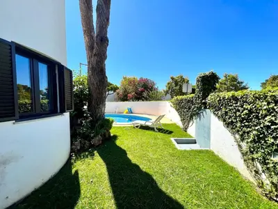a yard with a swimming pool and a tree at Vilamoura Traditional Villa with Pool by Homing in Vilamoura