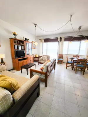 a living room with couches and a dining room at T2-MAMAMIA II Frente Mar in Quarteira