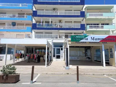 a large building with a store in front of it at T2-MAMAMIA II Frente Mar in Quarteira