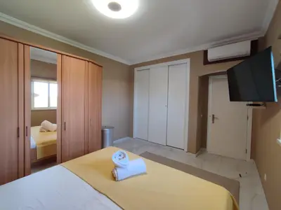a bedroom with a bed with a towel on it at Casa das Oliveiras o seu refugio no Algarve in Quarteira