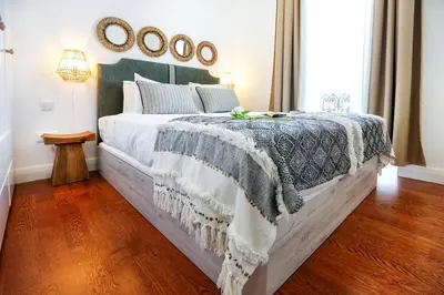 a bedroom with a bed with a blanket on it at Offline Mood Apartment in Faro