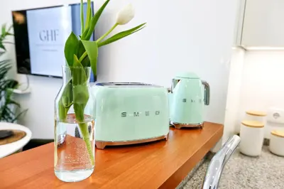 a wooden table with a vase with a flower in it at Offline Mood Apartment in Faro
