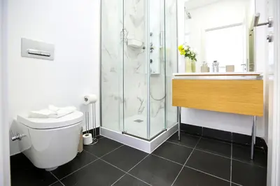 a bathroom with a shower and a toilet and a sink at Offline Mood Apartment in Faro