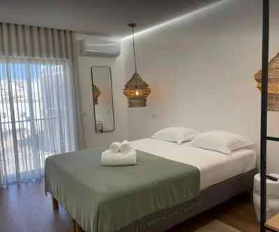 a bedroom with a bed with two towels on it at Pontinha Exclusive Apartment in Faro