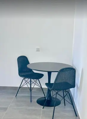 two chairs and a table and a table and chairs at Pontinha Exclusive Apartment in Faro