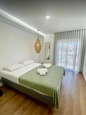 a bedroom with a large bed with two towels on it at Pontinha Exclusive Apartment in Faro