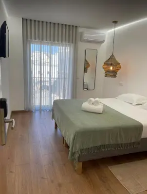 a bedroom with a bed with two towels on it at Pontinha Exclusive Apartment in Faro