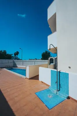 a swimming pool on the side of a house at Torre da Aldeia by Umbral in Albufeira