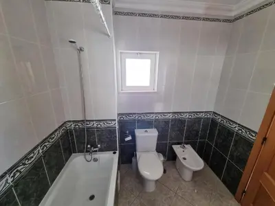 a bathroom with a toilet and a tub and a sink at Torre da Aldeia by Umbral in Albufeira