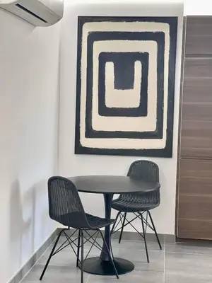 a table and two chairs in a room with a painting at Pontinha Exclusive House in Faro