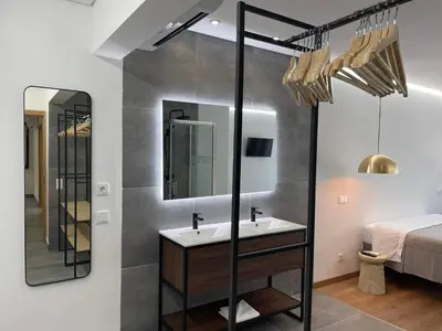 a bathroom with a sink and a mirror at Pontinha Exclusive House in Faro