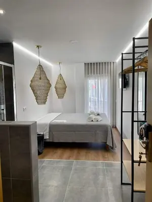 a bedroom with a bed and two hanging baskets at Pontinha Exclusive House in Faro