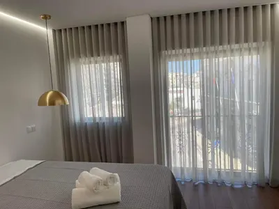 a bedroom with a bed with a white towel on it at Pontinha Exclusive House in Faro