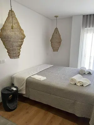 a bedroom with a bed with towels on it at Pontinha Exclusive House in Faro