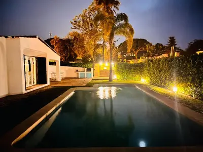 a swimming pool in a backyard at night at Amazing - VillaAnas Balaia in Albufeira