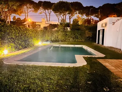 a swimming pool in a yard at night at Amazing - VillaAnas Balaia in Albufeira